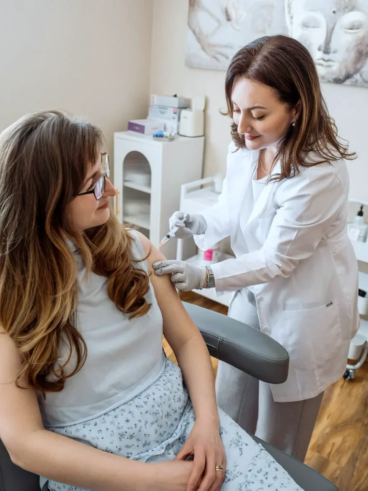 A vitamin injection being given in a client's upper arm